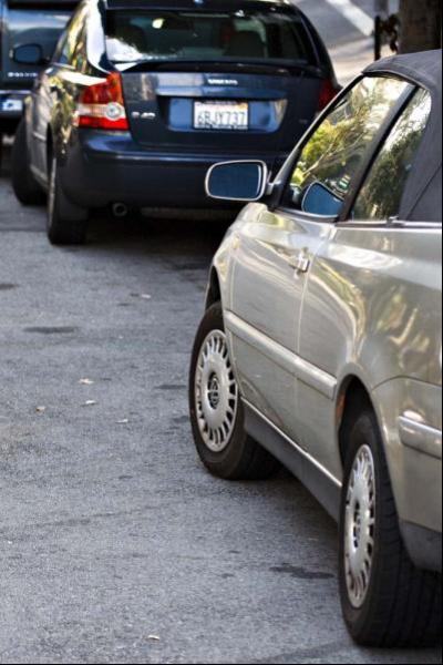 Photograph of cars parked on a street